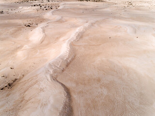 Wall Mural - Aerial view of sandy wavy dunes in Lancelin, Western Australia. Sunny day in summer with bright sand. Top view. Coastal, Seascape. Aerial view of beautiful sand dunes.