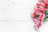Fototapeta Storczyk - Beautiful Alstroemeria flowers on wooden background