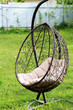 Hanging beautiful swing in the garden, a chair for outdoor recreation