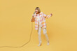 Full body singer happy fun elderly blonde woman 50s years old she wears casual clothes sing song in microphone at karaoke club isolated on plain yellow background studio portrait. Lifestyle concept.
