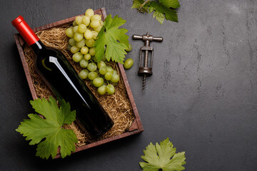 Wall Mural - A red wine bottle and fresh grapes