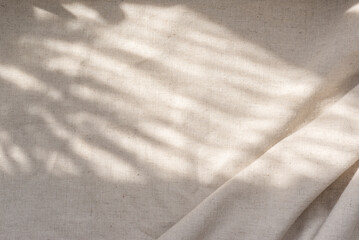 beige linen fabric texture with folds and natural floral sunlight shadows, aesthetic summer wedding 