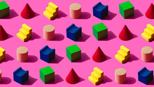 3D Pattern Of Colorful Toy Blocks Flat Laid Against Pink Background