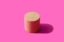 3D Render Of Wooden Cylinder Against Pink Background