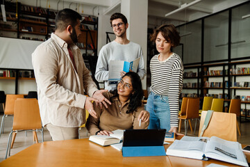 Group of students working on university project in college library