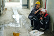 © AnnaStills - Worker receiving industrial injury in factory and colleague wrapping his injured head with bandage