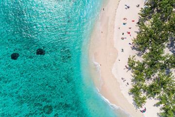 Wall Mural - Aerial view of beautiful tropical beach turquoise ocean sea waters with shallow waves. Vibrant bright sunny day in summer. Coastal seascape. Vacation holiday sunny beach. Le Morne, Mauritius
