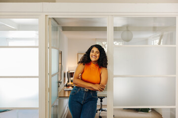 Wall Mural - Happy young businesswoman smiling at the camera