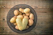 Bowl with potatoes on wooden table.