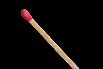 Matchstick with its red match and its wooden stick in extreme close-up on a black background