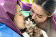 Young Asian lesbian couples kissing cat, LGBTQ and pride month Concept