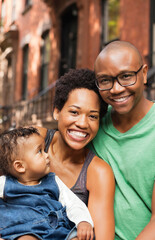 Wall Mural - Family smiling together on city street