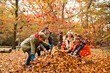 © KOTO - Family playing in autumn leaves