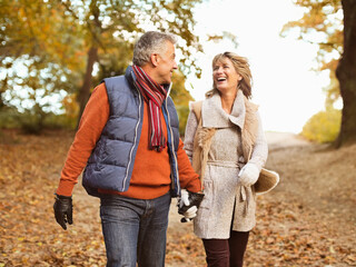 Wall Mural - Older couple walking together in park