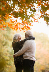 Wall Mural - Older couple hugging in park