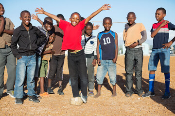 Wall Mural - Boys cheering together in dirt field