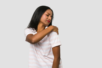 Wall Mural - Young Indian woman cut out isolated on white background having a shoulder pain.