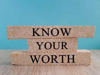 Know your worth symbol. Brick blocks with words Know your worth. Beautiful blue background. Business and Know your worth concept.