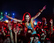 © KOTO - Cheering woman on man shoulders at music festival