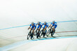 © KOTO - Track cyclists riding in velodrome
