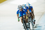Track cycling team riding in velodrome