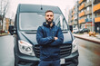 © VisualProduction - Delivery man standing in front of his van. Delivery man smiling and posing in front of delivery truck. Generative AI
