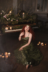 fairy red hair woman sitting on the floor near the grand piano decorated with candles, flowers and plants, fantasy druid queen