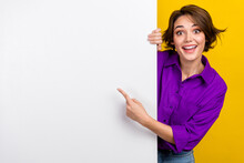 Portrait Of Cheerful Person Direct Finger Empty Space Billboard Proposition Isolated On Yellow Color Background