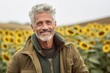 © Markus Schröder - Medium shot portrait photography of a satisfied mature man wearing a warm parka against a sunflower field background. With generative AI technology