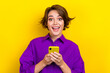 canvas print picture - Portrait of surprised girl bob brown hair wear purple shirt hold phone unexpected salary day emotion isolated on yellow color background