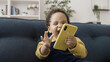 © Synthex - Extremely happy African American baby playing with parent's smartphone, childhood