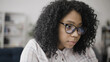 © Synthex - Concentrated African American woman looking at her computer display, reflection visible in her eyeglasses