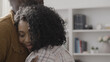 © Synthex - Happy African American couple hugging at home, contented family, relationship goals