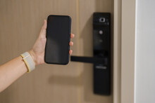 Hand Using Smartphone For Open Digital Door Lock At Home Or Apartment. NFC Technology, Fingerprint Scan, Keycard, PIN Number, Smartphone, Electrical And Contactless Lifestyle Concepts
