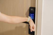 Hand using smartwatch for open digital door lock at home or apartment. NFC Technology, Fingerprint scan, keycard, PIN number, smartphone, electrical and contactless lifestyle concepts