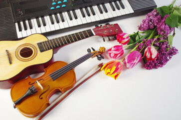 Wall Mural - Guitar, violin, synthesizer and a bouquet of tulips and lilacs.