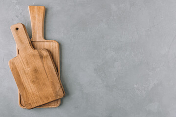 Wall Mural - Chopping boards. Empty wooden cutting boards on gray stone background