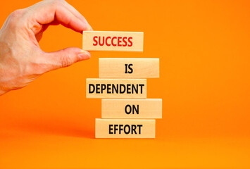 Wall Mural - Success and effort symbol. Concept words Success is dependent on effort on wooden block. Beautiful orange table orange background. Businessman hand. Business success and effort concept. Copy space.
