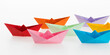 © xy - Colorful origami boats on white background