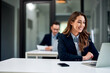© bnenin - A smiling female employee having a video call with a client over a laptop.