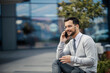 © Dusan Petkovic - A young busy man in smart casual is sitting in front of a business center and making a phone call.