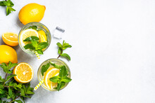 Lemonade In Glass With Fresh Lemons And Mint. Cold Summer Drink Top View With Copy Space.