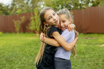 Children hugging and having fun outdoors. Family, childhood and vacation concept.