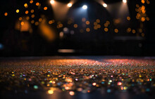 A Colorful Stage With Blurred Lights And Golden Glitter