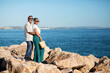 Happy European Senior Couple Hugging Near Ocean Posing Outside