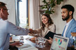 © Halfpoint - Close up of businesmans shaking hands in office.