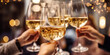 © Jasmina - Close up of group of friends toasting with glasses of white wine at restaurant