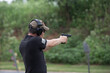 © Yunique - Man shooting with a gun at the outdoor range