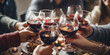 © Jasmina - Close up of group of friends toasting with glasses of red wine at restaurant
