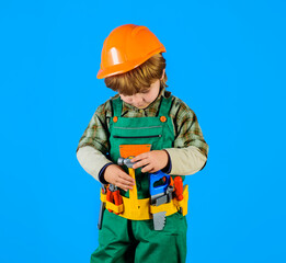 Wall Mural - Little kid repairman with toolbelt. Tools for building. Builder boy in safety helmet and toy tools for repair. Little child in builder's uniform with tool belt. Work with tools. Child game. Repair.